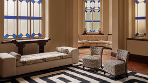 Haw Par Mansion living room featuring Permanent Resident Chaise reupholstered in Clarence House Tibet Fabric and Permanent Slipper Chairs in Black and White Larsen Fabric and Permanent Resident Bowie Dhurrie in Black and White Graphic Pattern