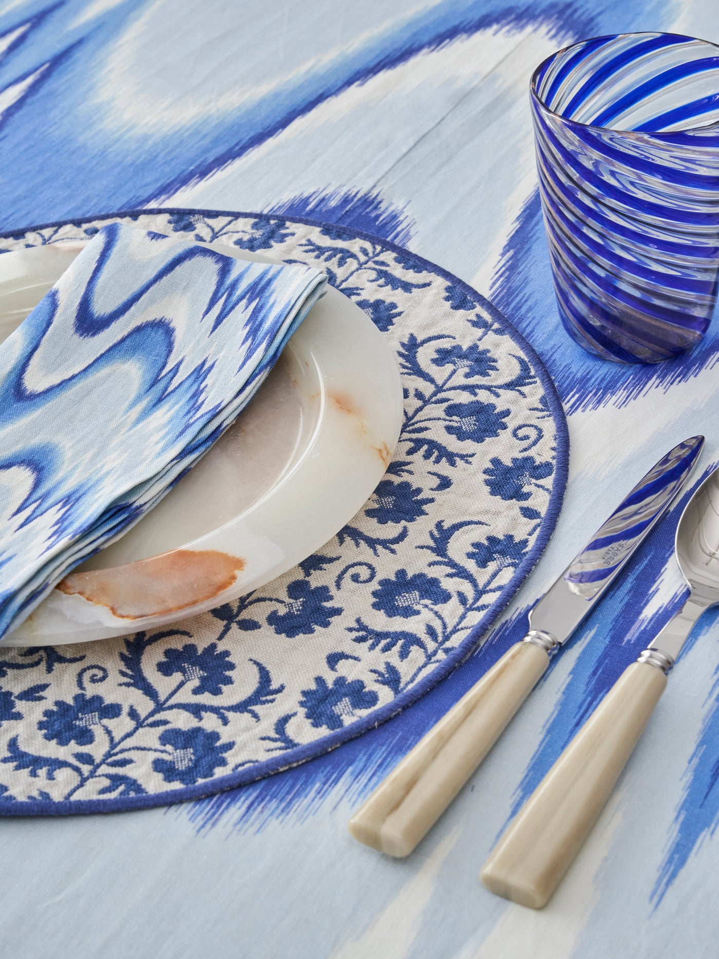 Blue Tablescape Suzani Placemat Aurora Flamestitch Linen Sabre Flatware Murano Glass