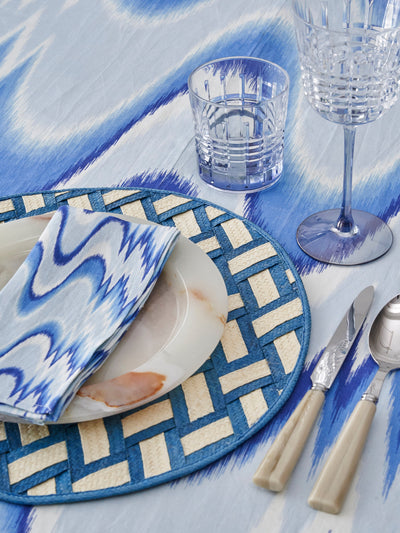 Blue and White Tablescape featuring our Aurora flamestitch tablecloth and coordinating napkins, and zenu braided placemats from Adriana Castro